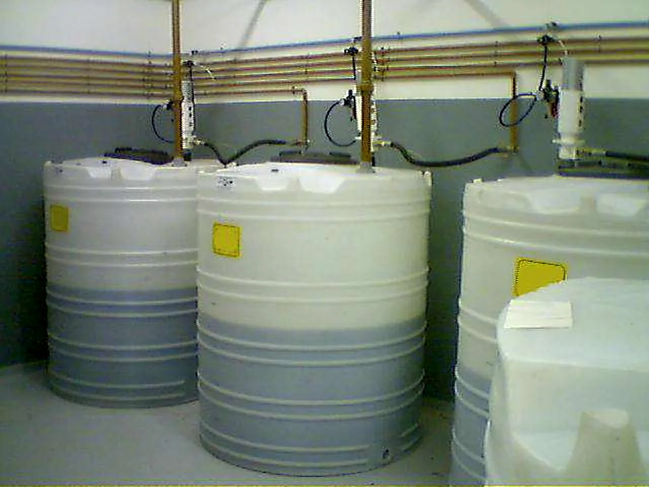 Three bulk oil tanks connected to overhead lines