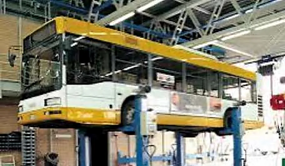 A bus raised on mobile column lifts