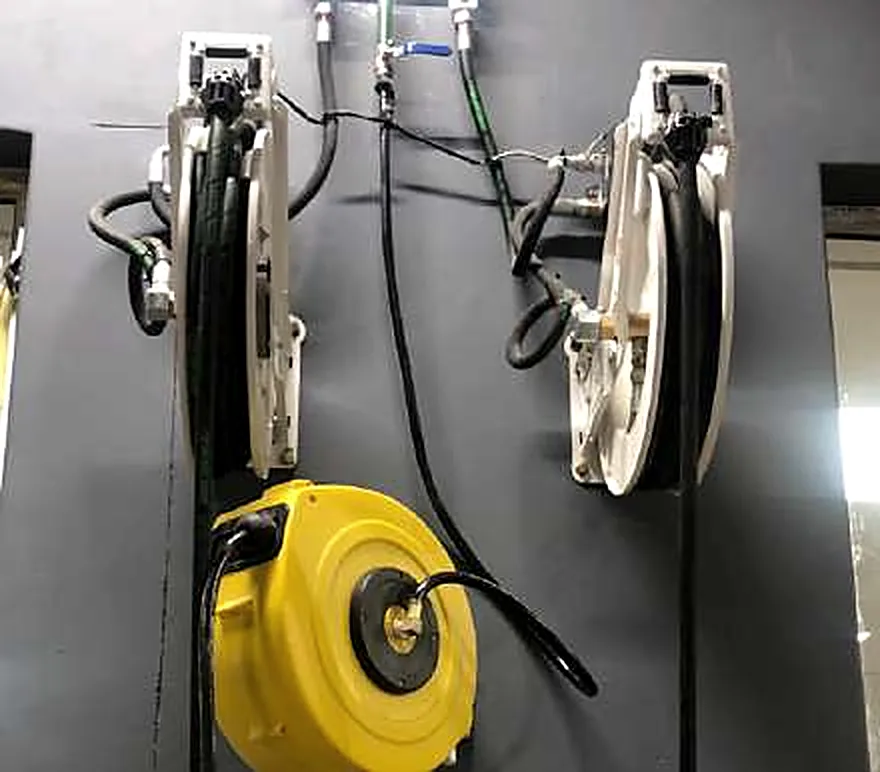 Hose reels mounted on a workshop wall